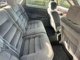 the interior of a car with two rows of seats in it