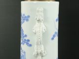 a white and blue vase with a light on it