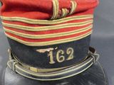 a red hat with a gold number on it