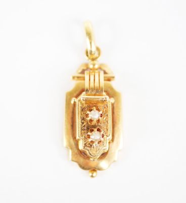 a close up of a gold locke with a diamond in the center