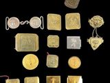 some gold and silver coins and other metal items on a black surface
