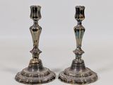 pair of antique silver candlesticks on a white background