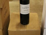 a bottle of wine sitting on top of a cardboard box