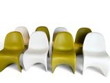 four different colored plastic chairs are lined up in a row