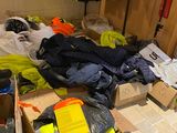 a pile of clothes and other items in a room