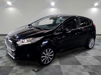 the black car is parked in the garage on the checkered floor