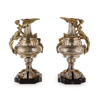 pair of antique silver vases on black marble bases