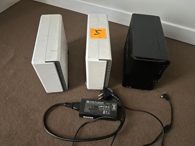 two speakers and a charger sitting on the floor