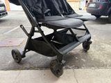 a baby stroller that is sitting on the sidewalk