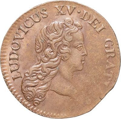 gros plan d'une pièce de monnaie sur laquelle figure une tête de femme