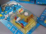 two blue and yellow toys that are on a table