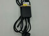 a close up of a black charger on a white surface