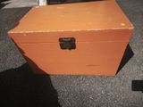 an orange box sitting on the ground outside