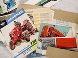 a pile of old farm manuals on a bed