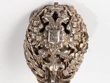 an image of a silver object on a white surface with a white background