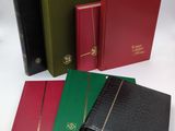 a group of four different colored books sitting on top of each other