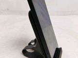 a cell phone that is on a stand on a table
