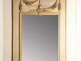 a mirror on the wall with a deer head above it