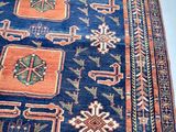 an image of a blue and orange rug on a white floor