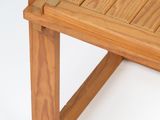 a wooden bench that is sitting on a white surface
