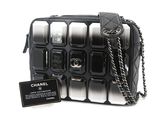 a black and white bag with a chain hanging from it