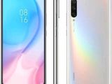 the front and back of a white smartphone with a rainbow background