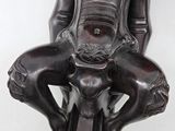 an image of a statue of a woman sitting on top of a chair