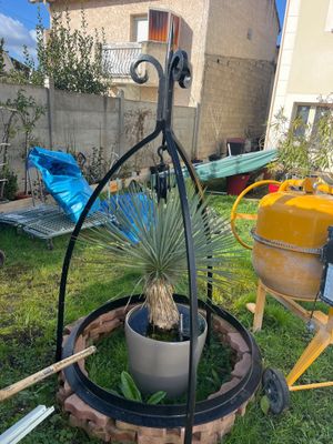 a potted plant in the middle of a plant stand