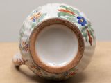a close up of a small vase on a table