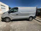 a silver van parked in a parking lot next to a building