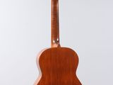 a wooden guitar hanging from a string on a white background