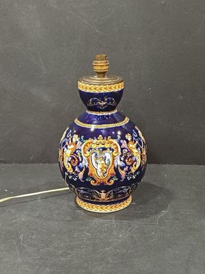 a blue and gold vase with a lion on it