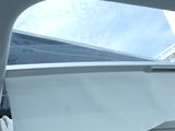 a view of a car ' s sunroof from the inside of it