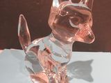 a glass cat figurine sitting on a table