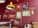 many menus on the wall of this restaurant