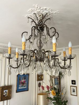 a chandelier that is hanging from the ceiling in a living room