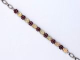 a close up of a bracelet on a white surface