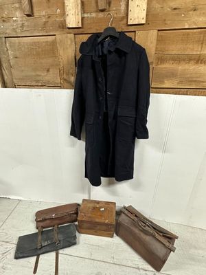 several pieces of luggage and a coat hang on a wall