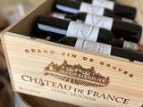 several bottles of wine in a wooden box on top of a table