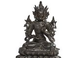 une image représentant une statue en bronze d'une personne assise sur un lotus