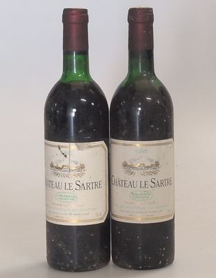 two bottles of wine sitting next to each other on a table