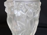 a glass vase with a design on it on a black background