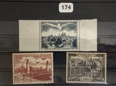 three stamps on display in a glass case on a wooden surface