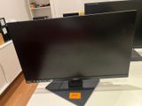 two computer monitors sitting on top of a desk in a room