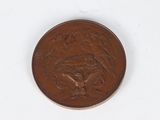 a close up of a penny on a white surface with a white background