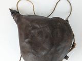 an overhead view of a brown leather bag with two handles