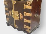 a wooden chest with gold and black designs on it