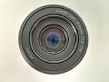 the lens of a camera is shown from above on a white surface
