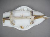 a white and gold plate with a cross on it