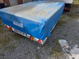a truck with a tarp on the back of it